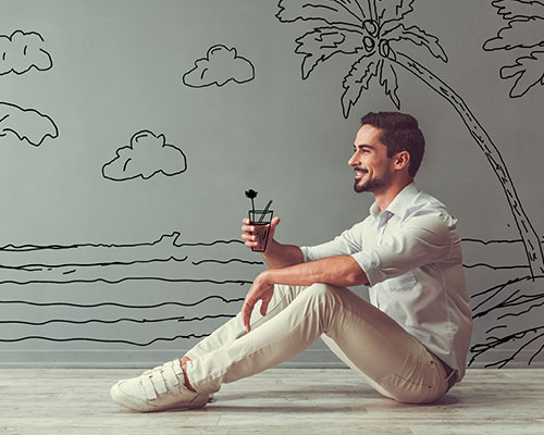 imagen de hombre con bebida tropical y de fondo un una pared con ilustración de unas palmeras y una playa.