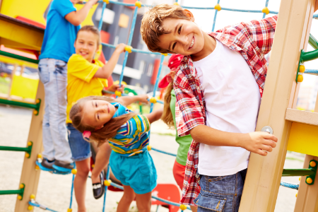  niños jugando en un parque en un rodadero